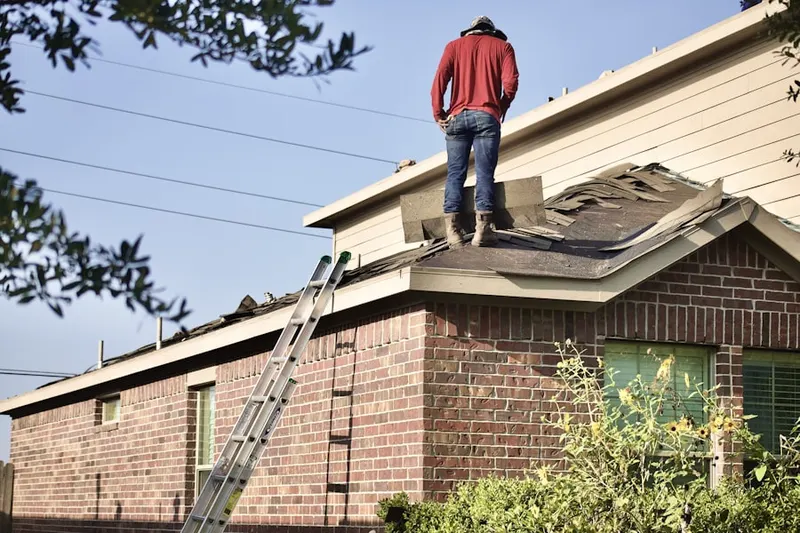 Professional roofer working on a residential roof in Troutdale